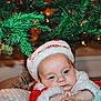 Jaxson joined the competition — help win amazing prizes! baby, christmas, santa_hat, holiday, festive, tree, lights, infant, cute, red_clothing, white_fur, indoors, decorations, seasonal, blue_eyes, face, portrait, sleepy, blanket, holiday_spirit