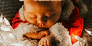Jaxson joined the competition — help win amazing prizes! baby, sleeping, christmas, santa_hat, holiday_lights, blanket, festive, cute, infant, red_clothing, white_fur, cozy, holiday_season, soft_texture, warm_lighting, toddler, peaceful, indoors, portrait, celebration