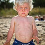toddler, child, beach, sand, swim_trunks, blond_hair, blue_eyes, summer, outdoor, sunlight, bare_chest, hands, playing, portrait, person, vacation, nature, casual, young, fun