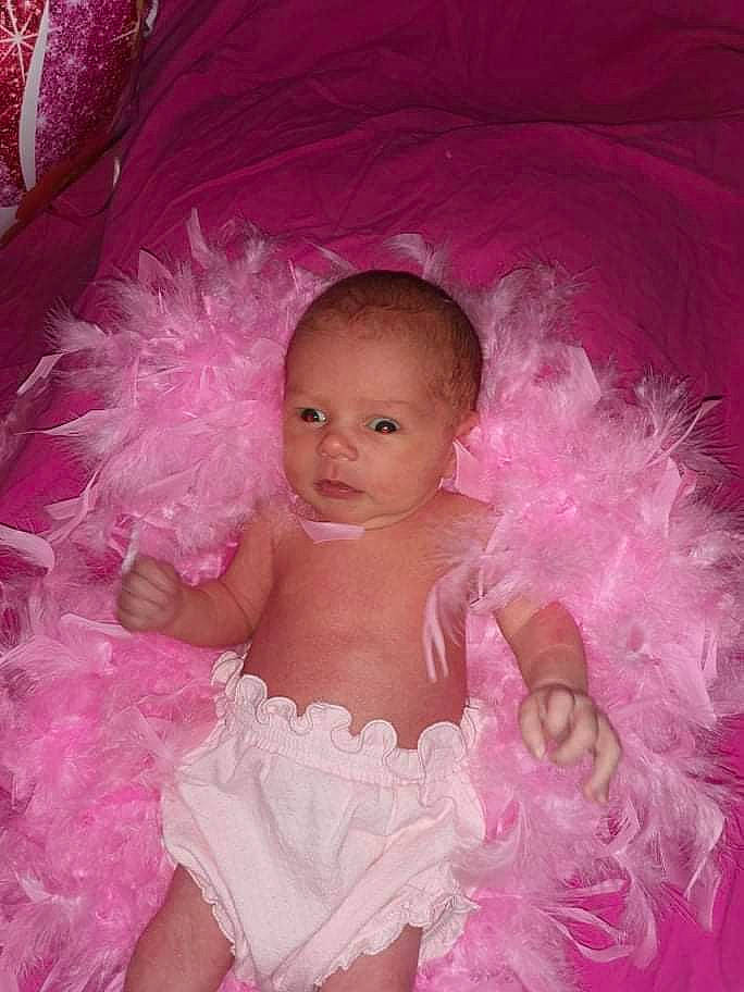 Yolaine participe au concours pour gagner de l'argent avec cette photo : arm, baby, baby_toddler_clothing, day_dress, dress, embellishment, event, fashion_accessory, hair_accessory, happy, headpiece, iris, magenta, person, petal, pink, purple, ruffle, smile, toddler