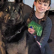 Bailey joined the competition — help win amazing prizes! animal, braids, casual_clothing, child, couch, dog, friendship, furniture, german_shepherd, girl, happy, home, indoor, person, pet, portrait, smiling, wall, wreath, young