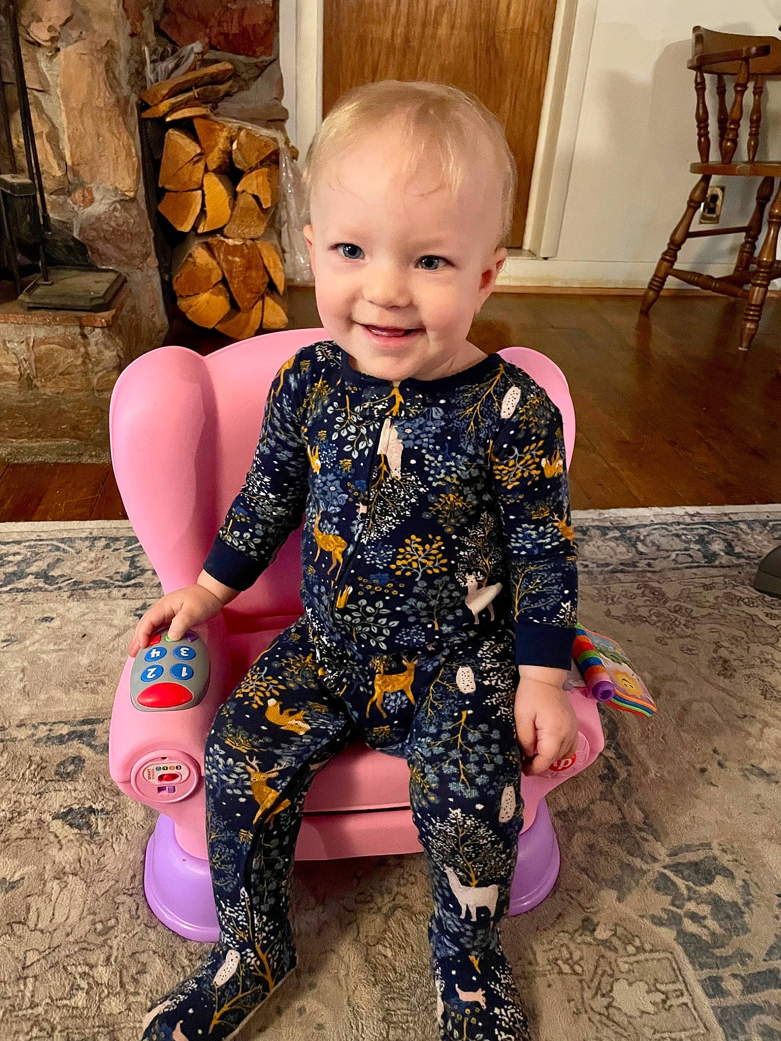 Brinley is registered to the contest to win money with this photo: baby, baby_toddler_clothing, chair, child, eye, face, flooring, fun, hair, happy, head, human_body, iris, joint, joy, person, pink, skin, sleeve, smile