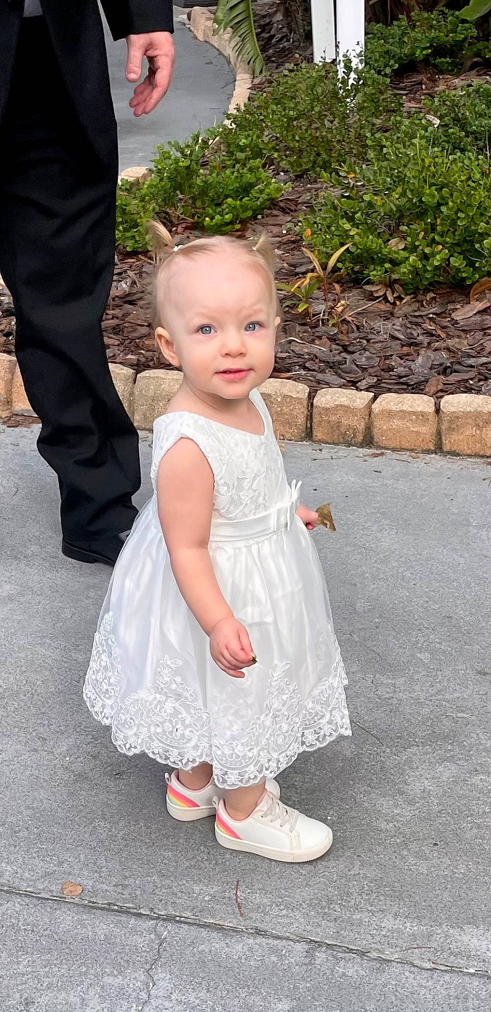 Brinley is registered to the contest to win money with this photo: arm, baby, baby_toddler_clothing, clothing, day_dress, dress, event, finger, formal_wear, fun, gesture, grass, happy, human_body, leg, person, plant, shoe, sleeve, smile