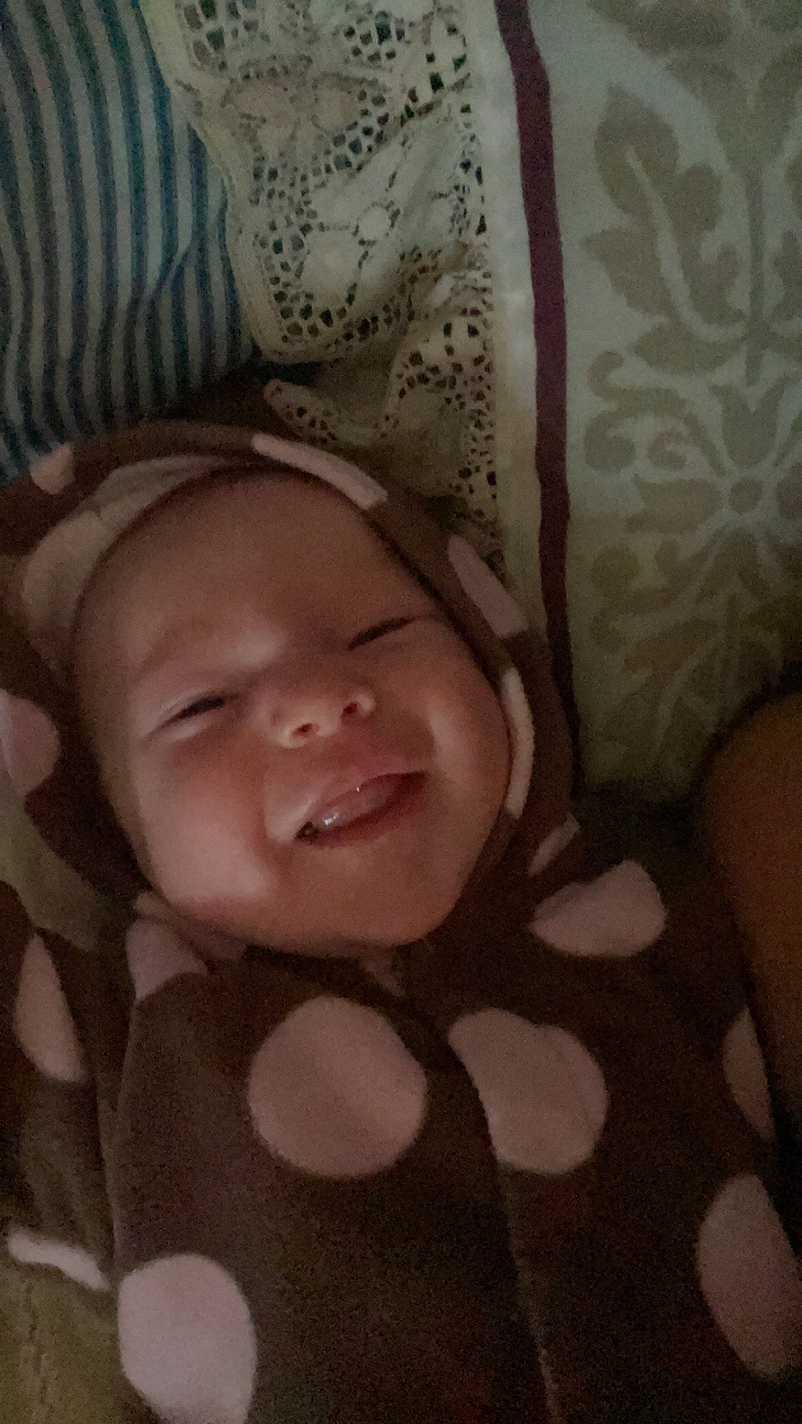 Bexley is registered to the contest to win money with this photo: baby, brown, cheek, chin, comfort, eye, eyebrow, face, facial_expression, finger, gesture, head, iris, lip, mouth, nose, person, skin, smile, textile