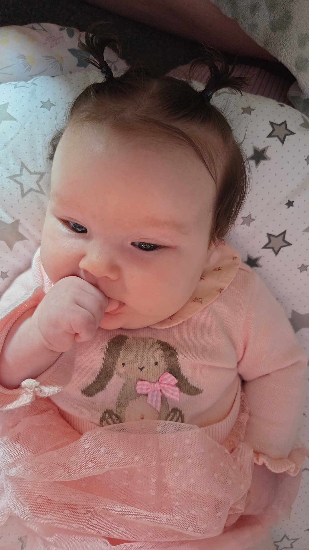 Lily-Mae is registered to the contest to win money with this photo: baby, infant, child, pink_clothing, tutu, bunny_design, pigtails, thumb_sucking, cute, adorable, star_pillow, soft_toys, closeup, portrait, indoor, sleeping_area, baby_girl, cozy, baby_outfit, happy