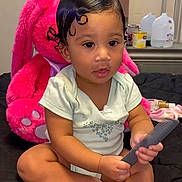 Mylonni joined the competition — help win amazing prizes! toddler, baby, child, comb, hair, curly_hair, plush_toy, pink_bunny, bed, black_bedspread, indoor, mirror, furniture, sitting, cute, person, short_sleeve, onesie, skin, hands