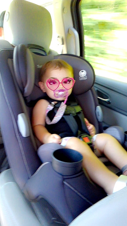 Elliana is registered to the contest to win money with this photo: auto_part, automotive_design, automotive_exterior, car, car_seat, car_seat_cover, comfort, eyewear, finger, fun, head_restraint, leg, mode_of_transport, motor_vehicle, person, product, seat_belt, smile, steering_part, steering_wheel
