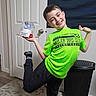 child, boy, smiling, portrait, indoor, soccer, basketball, sports, jersey, neon_green, black_pants, snow_globe, instant_snow_maker, toy, thumbs_up, posing, door, laundry_basket, rug, home