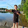 Eli joined the competition — help win amazing prizes! child, boy, fishing, fish, fishing_rod, outdoor, lake, waterfront, summer, sunny, smiling, portrait, nature, trees, sky, clouds, dock, reflection, shorts, sandals