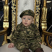 Amir joined the competition — help win amazing prizes! baby, child, military_uniform, camouflage, boots, chair, throne, golden, white_cushion, blue_eyes, indoor, portrait, person, cute, sitting, face, hat, expression, decor, young_child