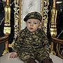 baby, child, military_uniform, camouflage, boots, chair, throne, golden, white_cushion, blue_eyes, indoor, portrait, person, cute, sitting, face, hat, expression, decor, young_child