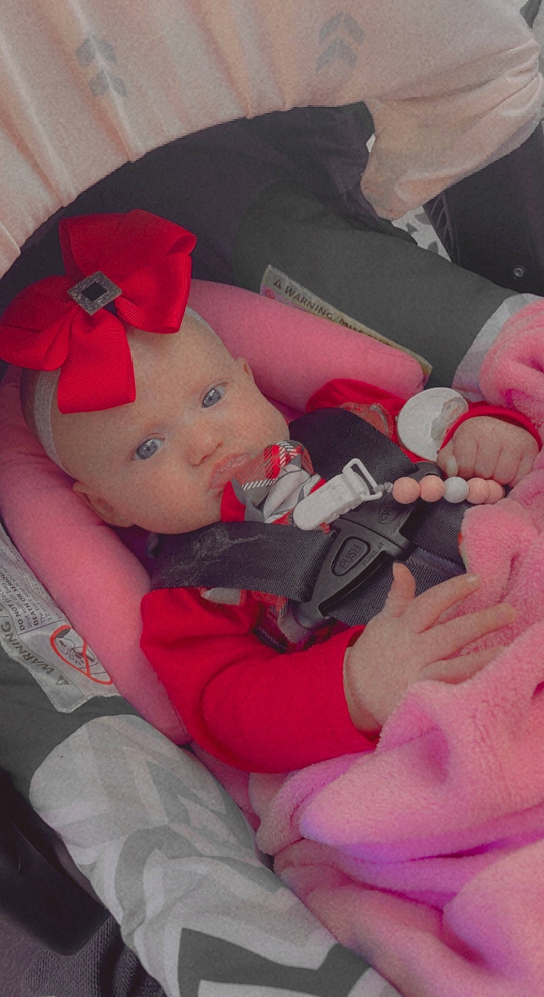 Paisley is registered to the contest to win money with this photo: arm, baby, baby_carriage, baby_sleeping, baby_toddler_clothing, cheek, child, comfort, finger, hand, headwear, human_body, lap, leg, mouth, person, pink, product, skin, thigh