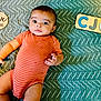 Christian joined the competition — help win amazing prizes! baby, infant, striped_clothing, orange_onesie, green_blanket, textured_blanket, wooden_plaque, five_months, puzzle, letters, elephant, milestone, lying_down, curious_expression, bright_eyes, indoor, child, person, cute, portrait