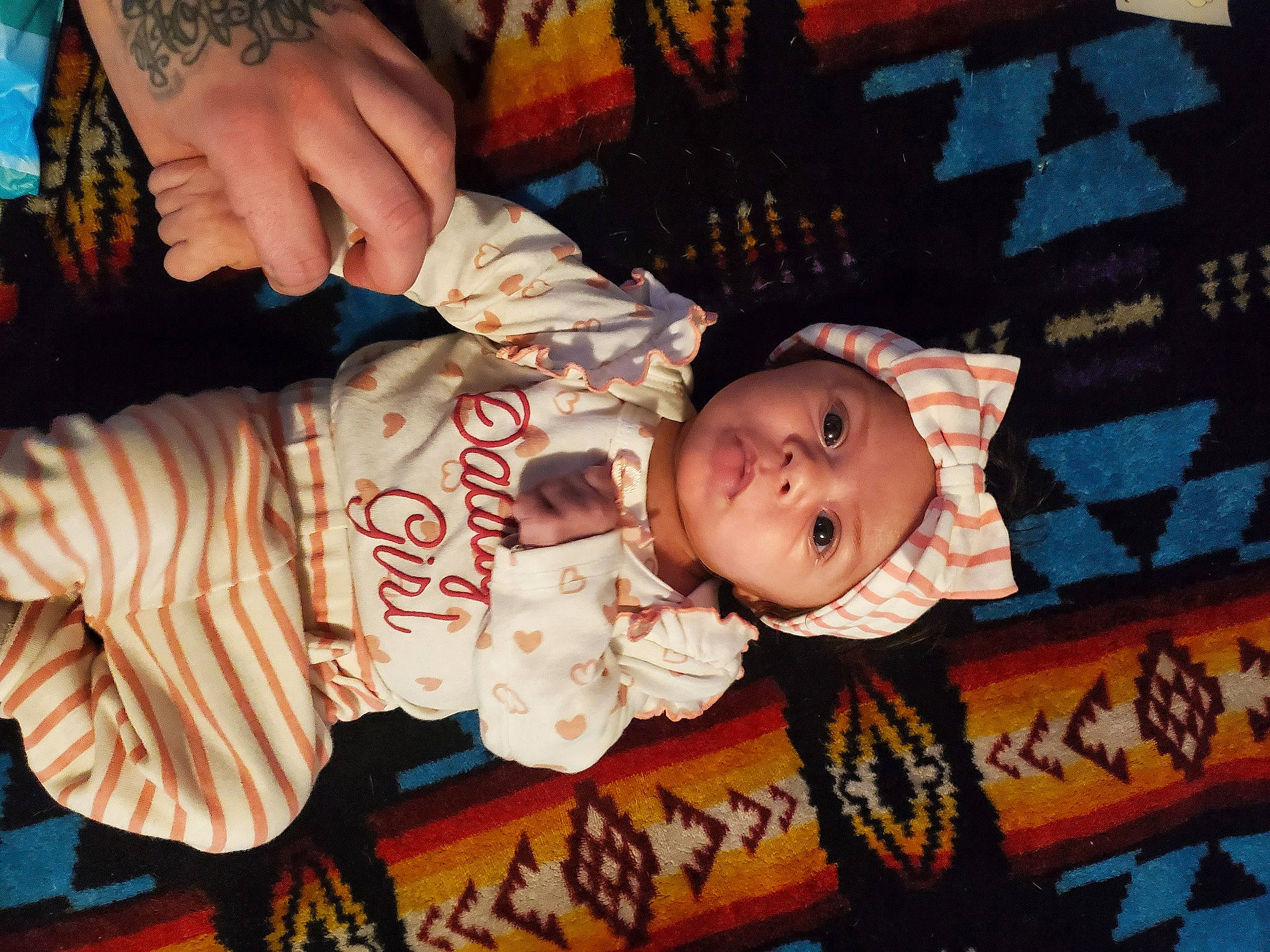 Love Ly Little is registered to the contest to win money with this photo: baby, baby_toddler_clothing, brown, cheek, child, fun, head, headwear, human_body, orange, pattern, person, room, sitting, toddler, wood