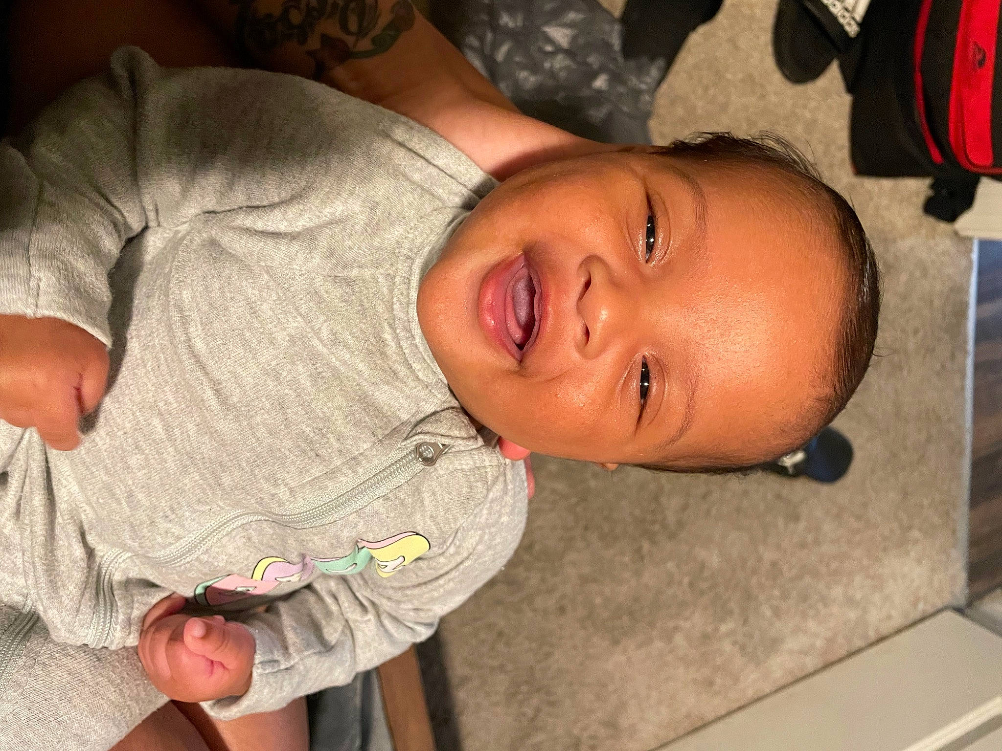 Phoenix Atalia is registered to the contest to win money with this photo: baby, baby_toddler_clothing, cheek, chest, chin, comfort, finger, forehead, fun, hand, happy, lip, mouth, neck, nose, person, skin, sleeve, smile, thumb