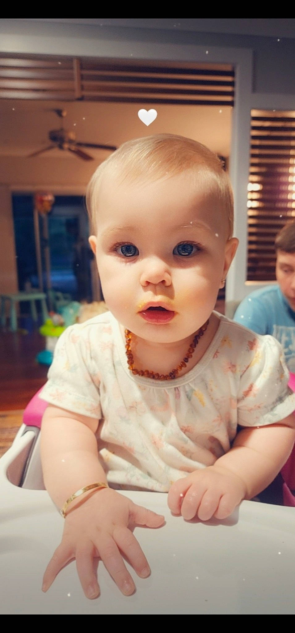 Sophie is registered to the contest to win money with this photo: baby, baby_toddler_clothing, ceiling_fan, chair, cheek, child, chin, dress, eyelash, flooring, fun, happy, iris, lip, nose, person, sitting, skin, sleeve, t_shirt