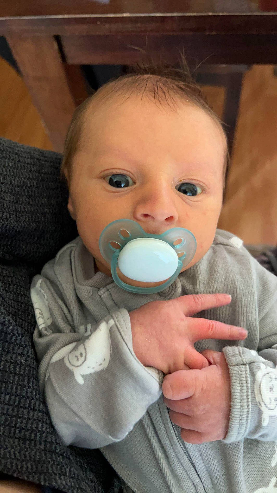 Cole is registered to the contest to win money with this photo: baby, baby_products, baby_toddler_clothing, cheek, child, clothing, comfort, eyelash, finger, gesture, hand, iris, mouth, nail, nose, person, sitting, skin, sleeve, thumb
