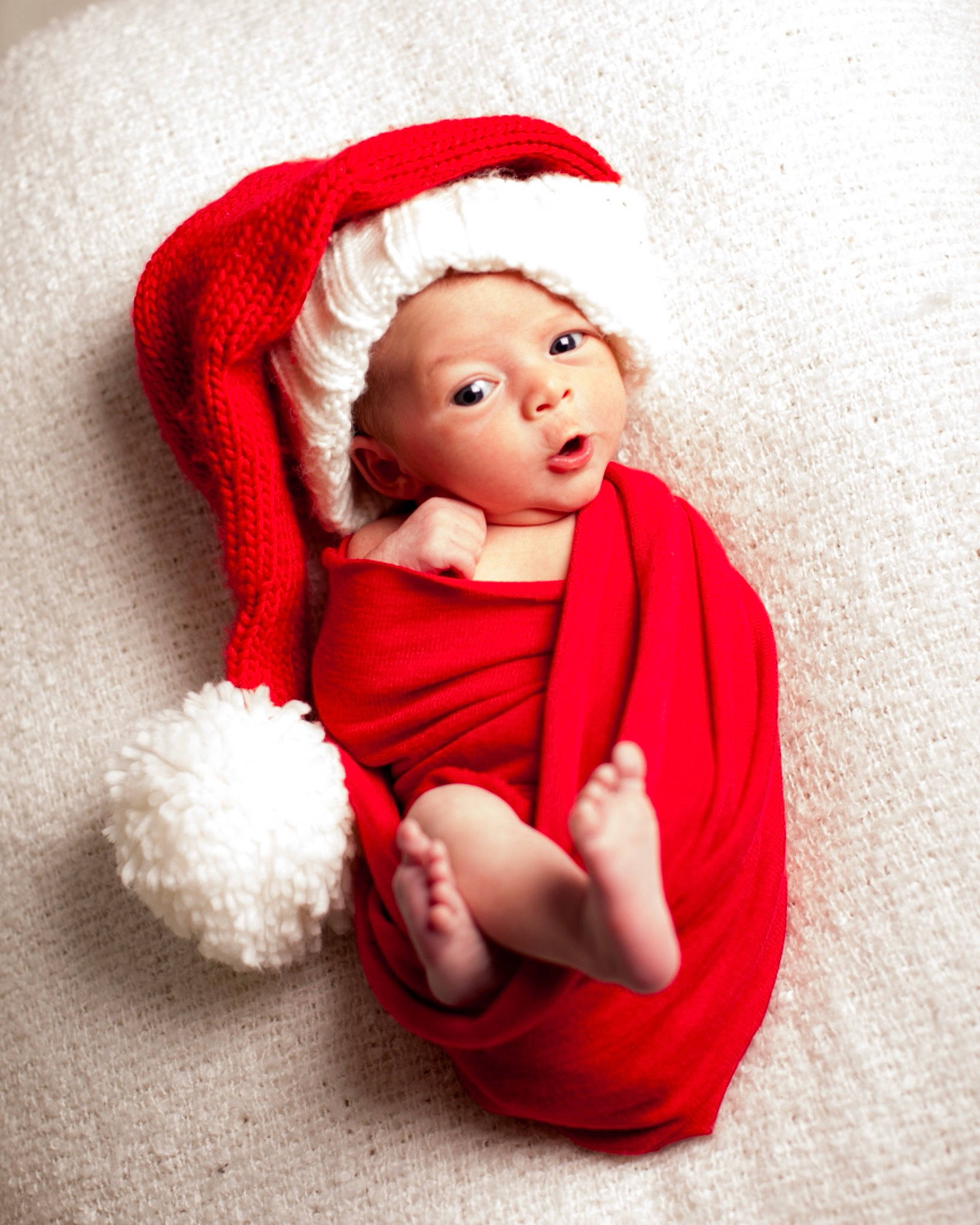 Amelia is registered to the contest to win money with this photo: baby, baby_toddler_clothing, cap, child, comfort, costume_hat, event, eye, fur, happy, headwear, human_body, lip, mammal, person, pink, product, santa_claus, sleeve, textile
