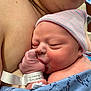 newborn, baby, infant, mother, skin_to_skin, hospital, wristband, hospital_bracelet, beanie, hat, swaddle, blanket, hand, mouth, sleeping, close_up, breastfeeding, parent, wardrobe, healthcare