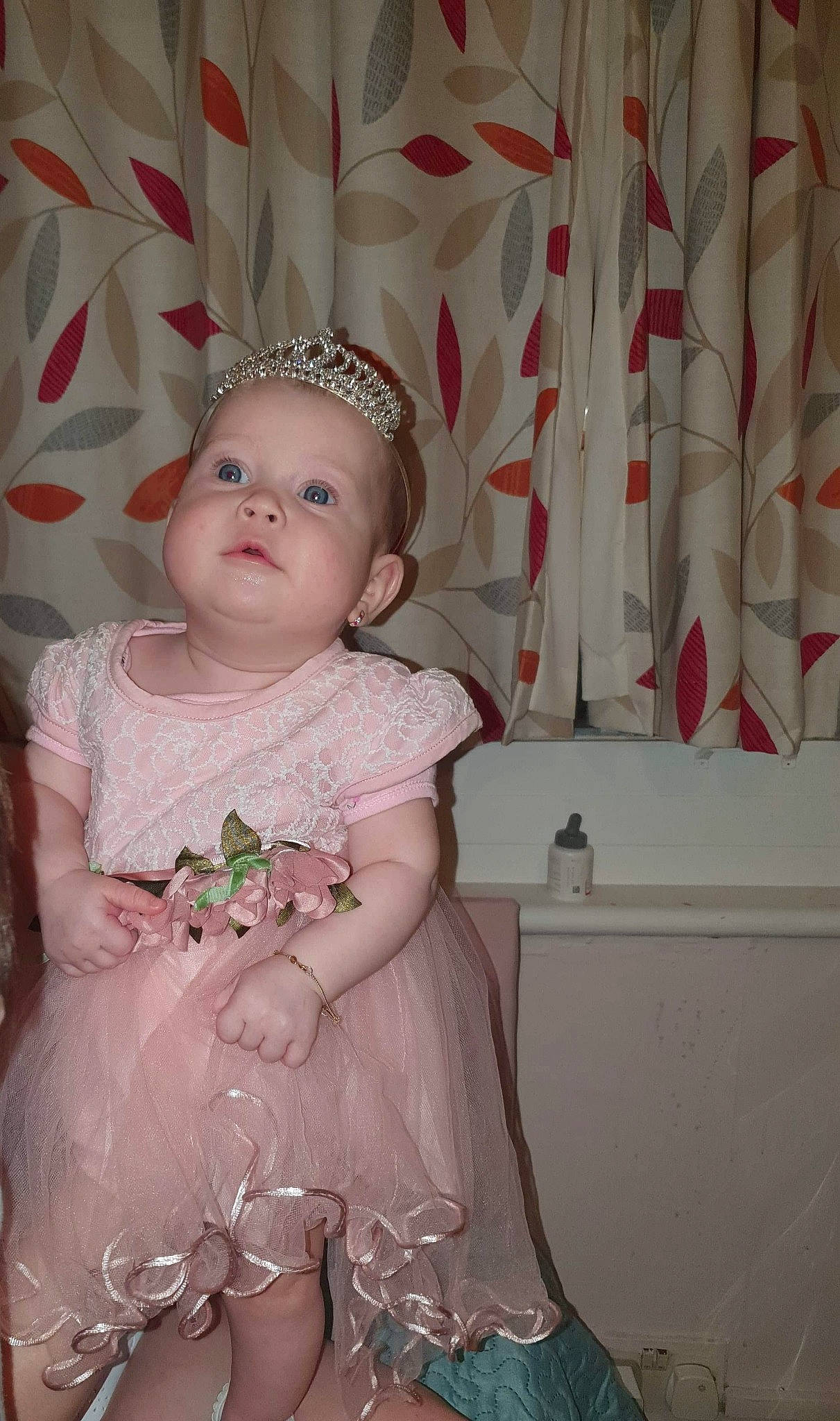 Miriam joined the competition — help win amazing prizes! baby, child, dress, fashion_accessory, hair_accessory, headgear, headpiece, iris, person, pink, skin, smile, standing, textile, toddler