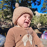 Max joined the competition — help win amazing prizes! child, toddler, smiling, outdoor, sunny, hat, brown_clothing, onesie, walrus_design, trees, nature, blue_sky, happy, laughing, person, daylight, cute, playful, warm_clothing, park