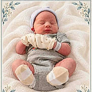 Carson is registered to the contest to win money with this photo: baby, newborn, sleeping, portrait, indoors, blanket, soft_blanket, hat, striped_hat, mittens, gray_clothing, overalls, polka_dots, baby_feet, socks, cuddly, peaceful, floral_border, decorative_frame, closeup