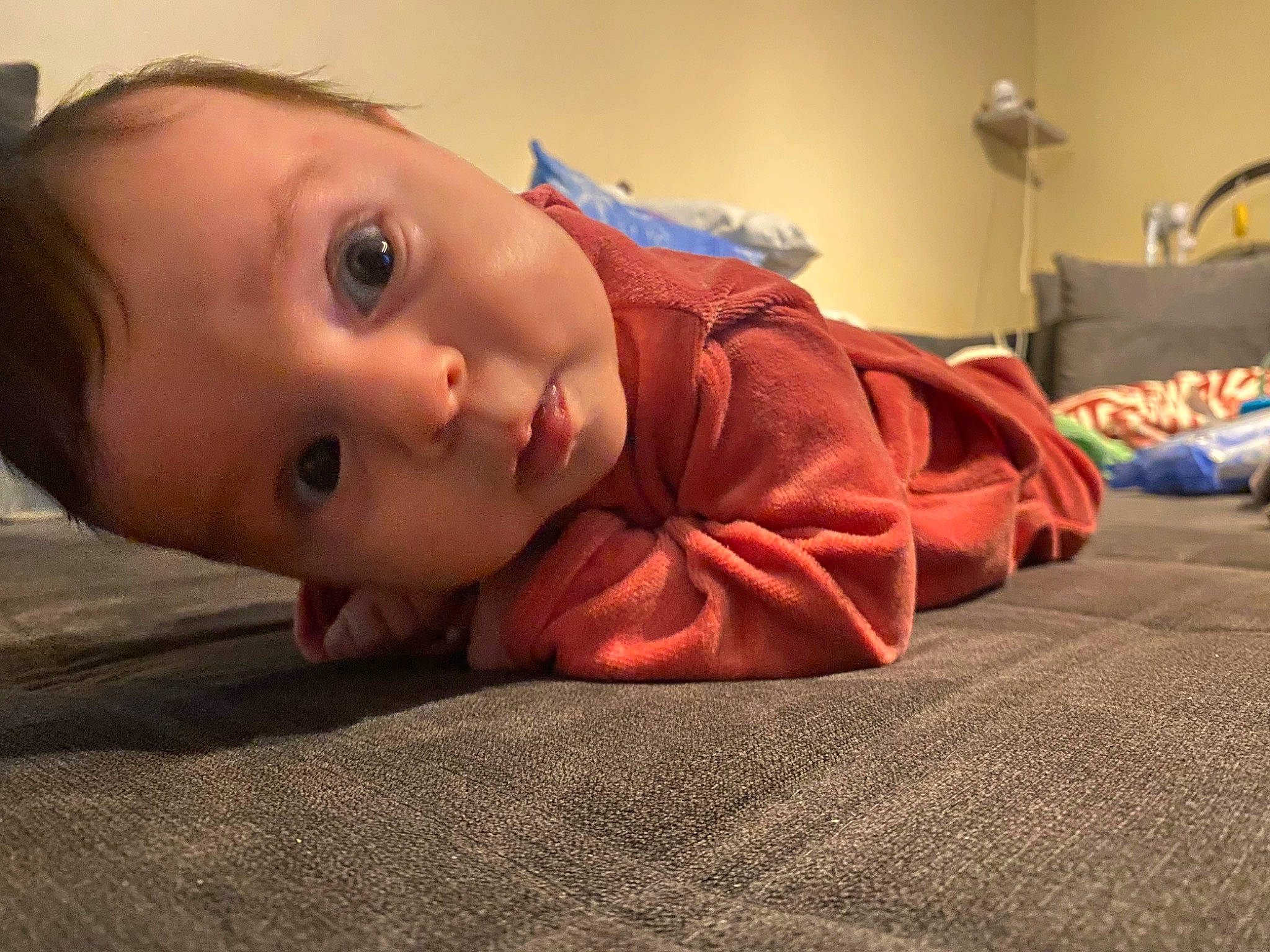 Rebecca participe au concours pour gagner de l'argent avec cette photo : baby, cheek, child, comfort, eyelash, floor, flooring, fun, hardwood, human_body, iris, linens, lip, nose, person, room, sitting, skin, toddler, tummy_time
