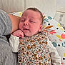 baby, infant, sleepy, floral_outfit, pillow, arm, gray_shirt, hand, cute, resting, indoor, person, child, newborn, pattern, fabric, comfort, closeup, face, skin