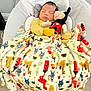 baby, sleeping, blanket, plush_toy, mickey_mouse, infant, baby_seat, soft_toy, striped_clothing, colorful, animal_print, indoors, flooring, comfort, resting, child, cute, peaceful, nursery, cozy