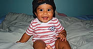 Matheo joined the competition — help win amazing prizes! baby, child, infant, smiling, happy, portrait, sitting, bed, bedroom, baseball_cap, backward_hat, striped_shirt, soccer_shirt, soccer_ball, clothing, barefoot, indoors, bedding, flash_photography, closeup