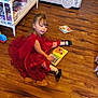 Oakley joined the competition — help win amazing prizes! child, girl, red_dress, floor, wooden_floor, books, reading, toys, shelf, playhouse, cardboard, scribbles, indoor, room, playtime, white_shelf, black_shoes, socks, long_hair, young