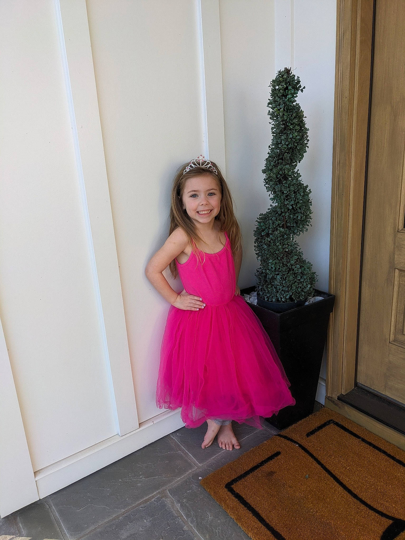 Raeanna is registered to the contest to win money with this photo: baby_toddler_clothing, clothing, day_dress, door, dress, event, face, fashion_design, flooring, formal_wear, hardwood, joy, long_hair, magenta, one_piece_garment, person, pink, purple, smile, toddler