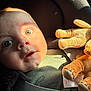baby, child, face, eyes, plush_toy, car_seat, seatbelt, sunlight, closeup, infant, cute, expression, soft_toy, child_seat, indoors, sitting, person, portrait, clothing, warm_light