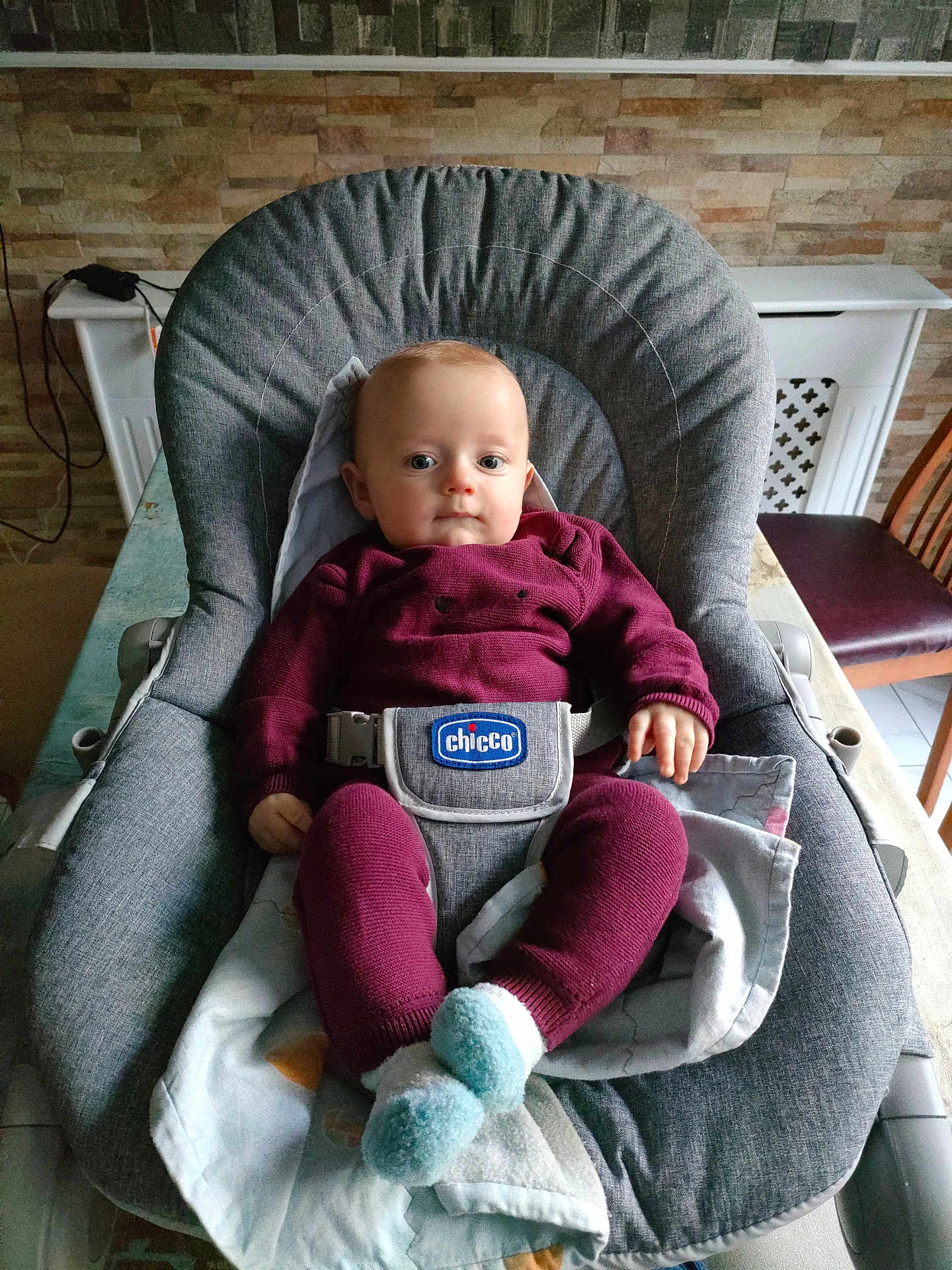 Antanas joined the competition — help win amazing prizes! baby, infant, child, baby_chair, maroon_clothing, socks, grey_chair, blanket, indoor, table, wooden_chair, wall, brick_pattern, face, person, seated, curious, soft_lighting, homedecor, baby_belt