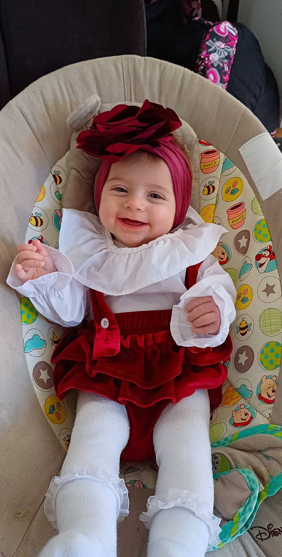 Kara participe au concours pour gagner de l'argent avec cette photo : baby, baby_products, baby_toddler_clothing, cheek, child, comfort, face, fictional_character, fun, happy, headwear, joy, lap, linens, magenta, pattern, person, pink, sitting, sleeve