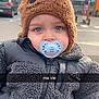 baby, beanie, bonnet, cap, city, clothing, coat, face, glove, hat, head, hood, jacket, person, photography, portrait, road, street, transportation, urban