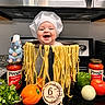 baby, child, infant, smiling, chef_hat, pasta, noodles, cooking, kitchen, food, spaghetti, vegetables, tomato, bell_pepper, onion, pasta_sauce, plush_toy, stovetop, portrait, six_months