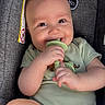Noah is registered to the contest to win money with this photo: baby, child, infant, smiling, happy, portrait, stroller, seated, teething_toy, green_toy, baby_clothing, onesie, hands, arms, legs, face, eyes, outdoor, close_up, cozy