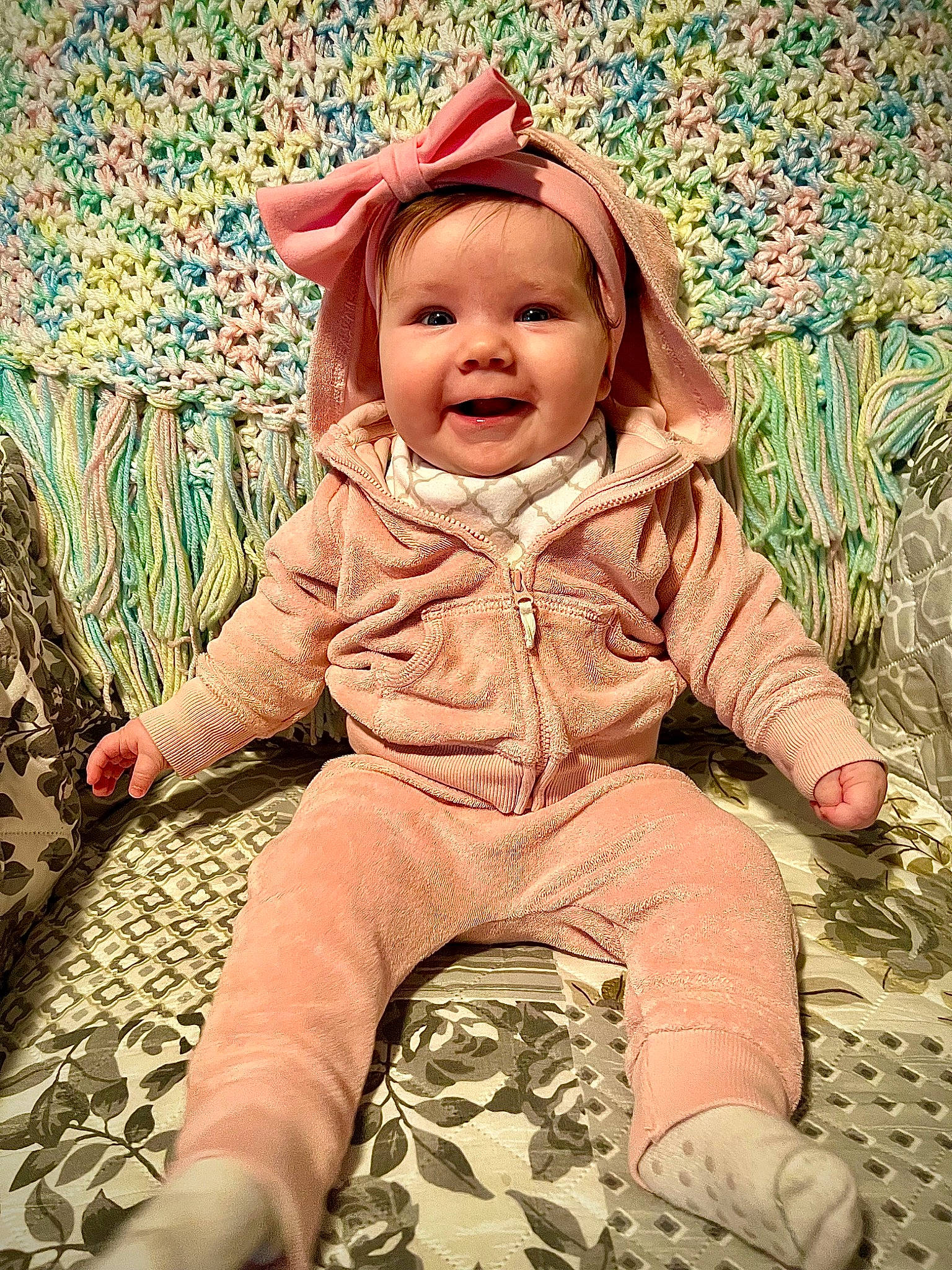 Charli is registered to the contest to win money with this photo: baby, baby_toddler_clothing, cheek, child, comfort, eye, face, flooring, fun, grass, happy, headwear, joy, pattern, people_in_nature, person, pink, sitting, skin, sleeve