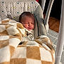 Marcus joined the competition — help win amazing prizes! baby, newborn, blanket, baby_swing, sleeping, indoor, soft_texture, patterned_fabric, cozy, child, infant, face, head, resting, comfort, warm, home, wood_floor, toy, peaceful