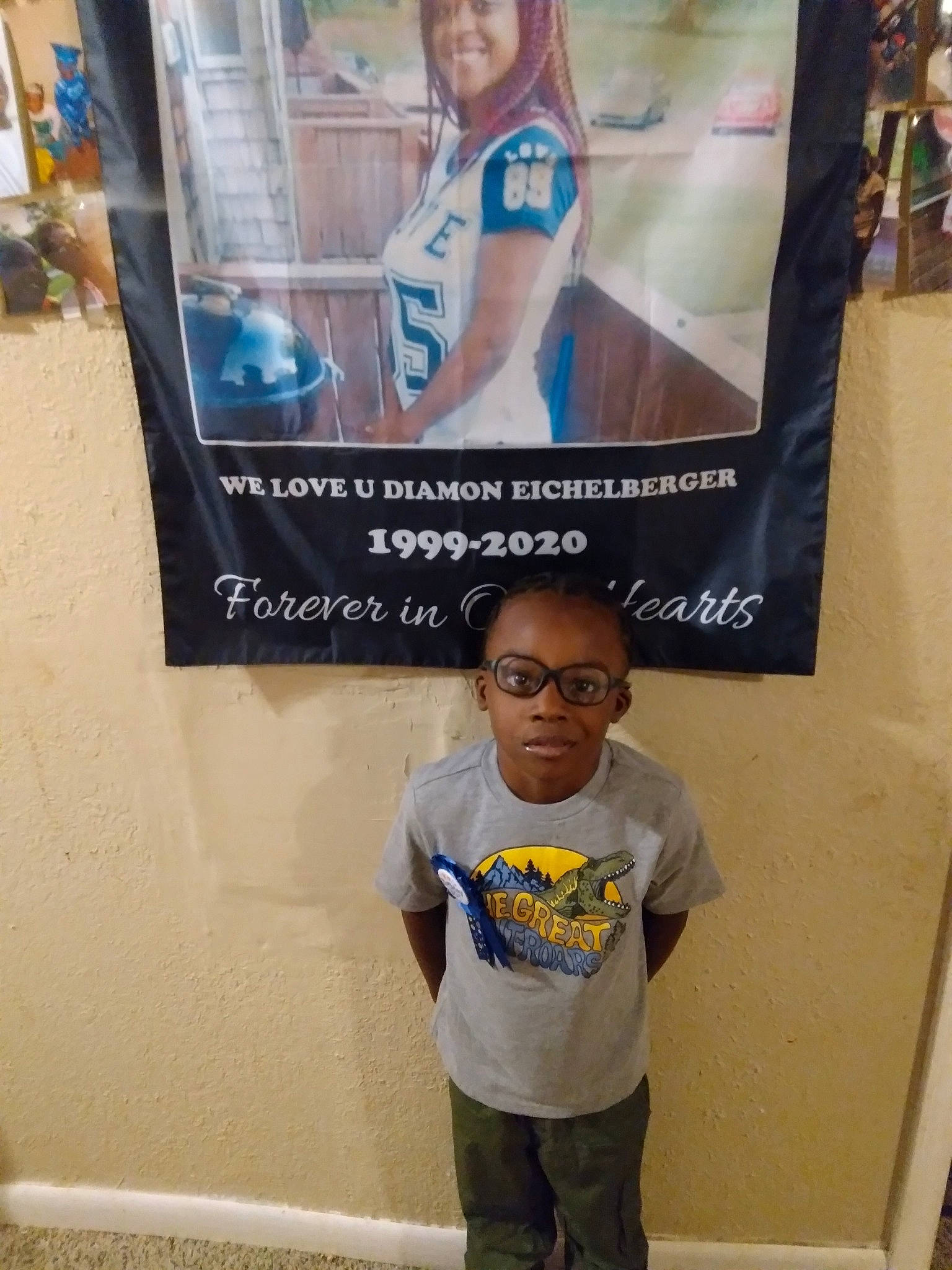 Brian is registered to the contest to win money with this photo: advertising, banner, child, event, eyewear, font, fun, hairstyle, person, photograph, photography, poster, room, sleeve, smile, snapshot, t_shirt, toddler, visual_arts, white