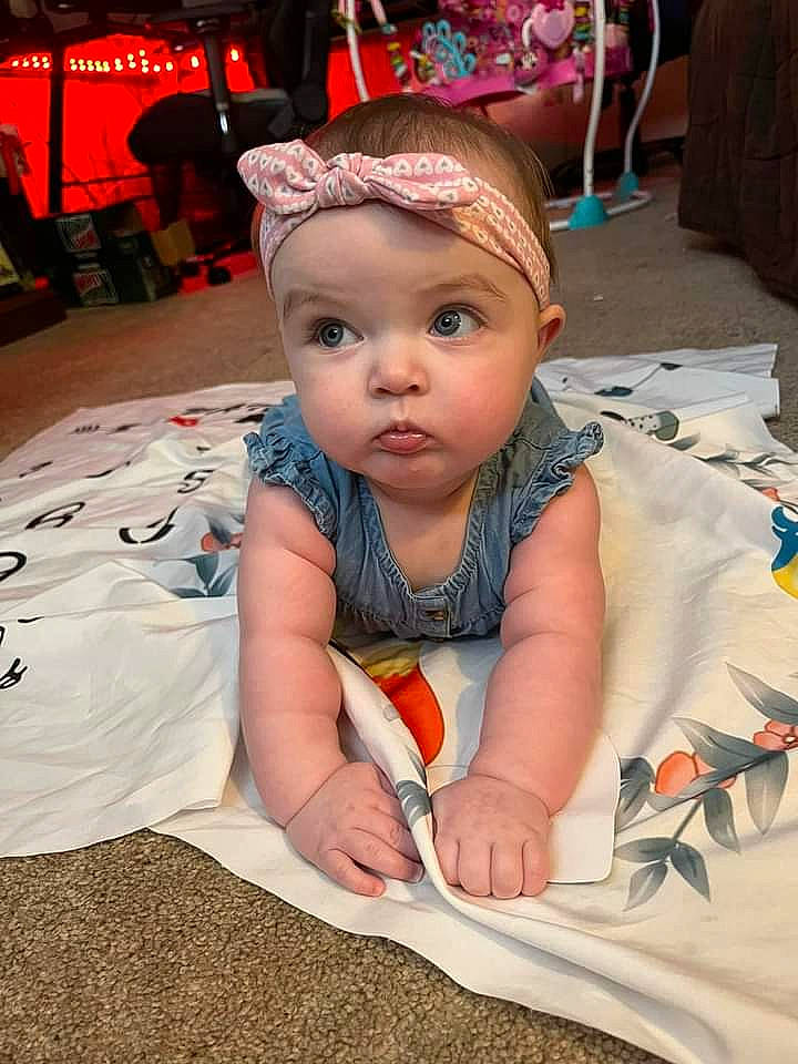 Alivia is registered to the contest to win money with this photo: baby, baby_toddler_clothing, cap, chair, child, costume, crown, event, fashion_accessory, flooring, fun, happy, headgear, headwear, jewellery, necklace, person, pink, sitting, skin