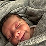 Ryker is registered to the contest to win money with this photo: baby, sleeping, blanket, cozy, soft, smile, face, infant, child, wrapped, cute, peaceful, indoors, warm, comfort, head, portrait, resting, newborn, toddler