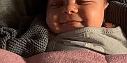 Ryker is registered to the contest to win money with this photo: baby, smiling, blanket, cozy, sleeping, infant, closeup, face, child, indoors, comfort, soft, cute, relaxed, small, portrait, resting, peaceful, warm, seated
