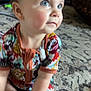 toddler, child, blue_eyes, colorful_clothing, patterned_outfit, sitting, carpet, indoor, floor, hand, foot, curious, young_child, skin, person, home, cute, infant, baby, portrait