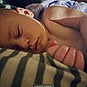 Amiyah is registered to the contest to win money with this photo: baby, blanket, child, closeup, cozy, face, hand, human, indoor, infant, peaceful, photo_editing, portrait, relaxation, resting, skin, sleeping, soft_light, striped_blanket, towel