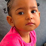 Shayanne a rejoint le concours — aidez-le/la à gagner de superbes lots ! toddler, child, portrait, face, curly_hair, pink_shirt, cherry_pattern, earring, indoor, couch, seated, cute, young_child, expression, skin, person, looking_away, hairstyle, casual_clothing, closeup