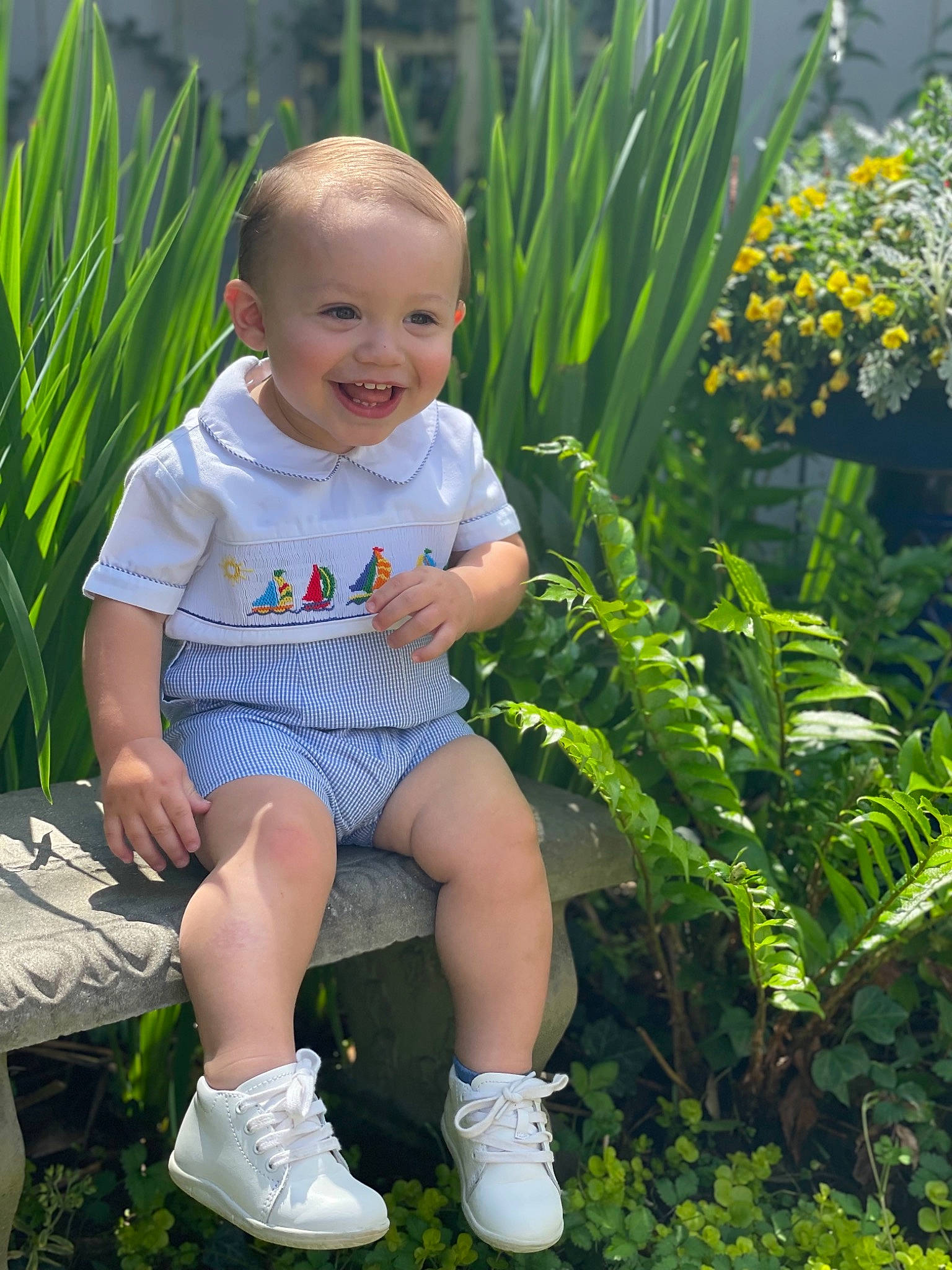 Colten is registered to the contest to win money with this photo: baby_toddler_clothing, botany, eye, facial_expression, flower, fun, grass, green, hairstyle, happy, iris, joy, leaf, leisure, nature, people_in_nature, person, plant, shorts, smile
