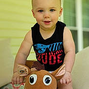 Walker joined the competition — help win amazing prizes! toddler, child, plush_toy, horse, indoor, couch, smiling, cute, black_shirt, blue_eyes, short_hair, toy, soft_toy, happy, baby, person, furniture, home, portrait, sitting