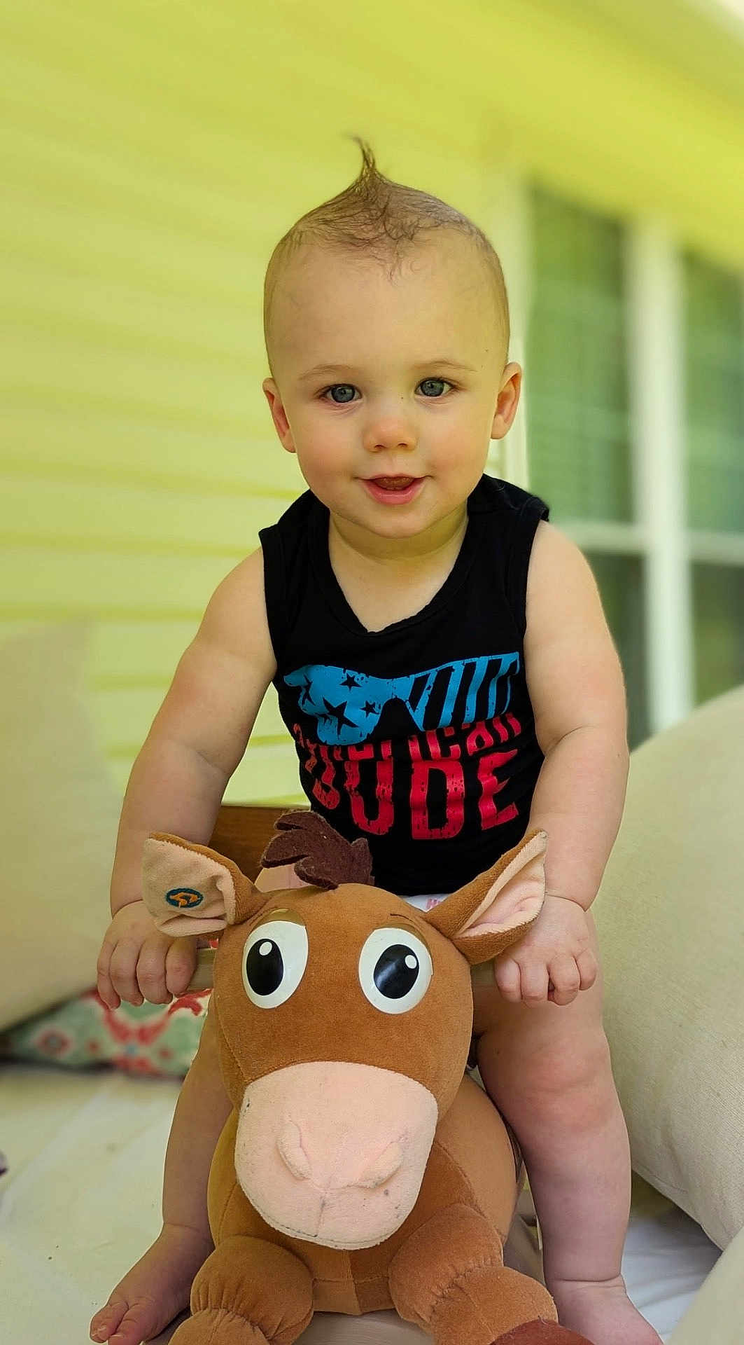Walker joined the competition — help win amazing prizes! toddler, child, plush_toy, horse, indoor, couch, smiling, cute, black_shirt, blue_eyes, short_hair, toy, soft_toy, happy, baby, person, furniture, home, portrait, sitting